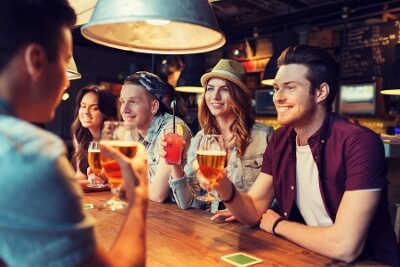 Young adults enjoying beer in a bar